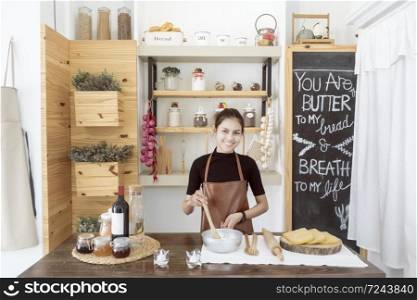 Beautiful woman is cooking in her kitchen