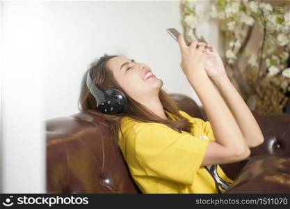 Beautiful woman is listening music in home