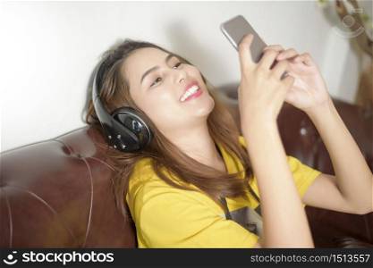 Beautiful woman is listening music in home