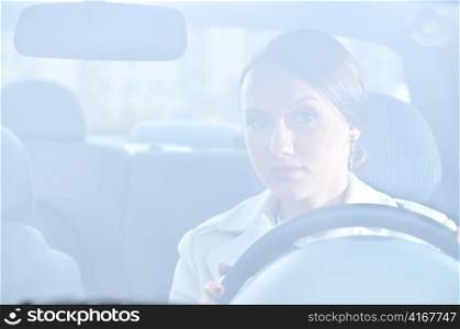 beautiful woman is sitting in her car