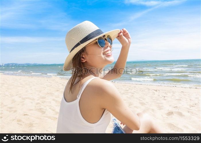 Beautiful woman is sitting on beach