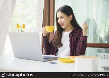 Beautiful woman is working with laptop computer in coffee shop