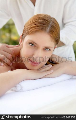 Beautiful woman laying on a massage bed