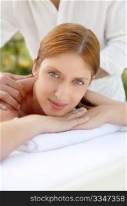 Beautiful woman laying on a massage bed