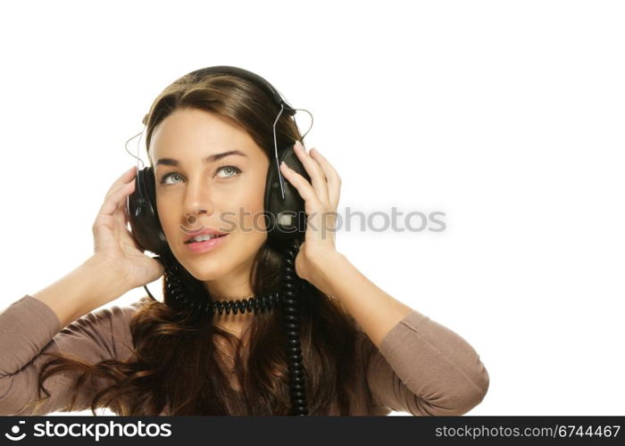 beautiful woman listening to music looking up. beautiful woman listening to music looking up on white background