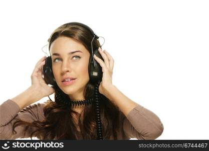 beautiful woman listening to music looking up. beautiful woman listening to music looking up on white background