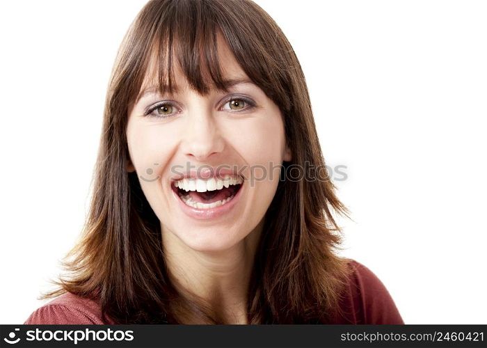 Beautiful woman looking at camera and laughing, isolated on a white background