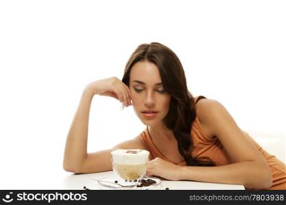 beautiful woman looking at the cappuccino coffee in front of her on the table. beautiful woman looking at the cappuccino coffee in front of her on the table on white background