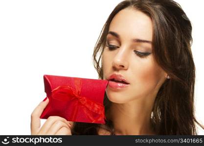 beautiful woman looking at the present near her face. beautiful woman looking at the present near her face on white background