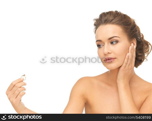beautiful woman looking at wedding ring and thinking