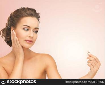 beautiful woman looking at wedding ring and thinking. woman with wedding ring
