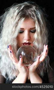 Beautiful woman looking into a crystal ball