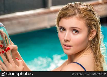 beautiful woman looking into the camera shooting in the pool