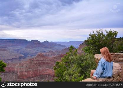 Beautiful woman looking out at the Grand Canyon from the South Rim, Usa.