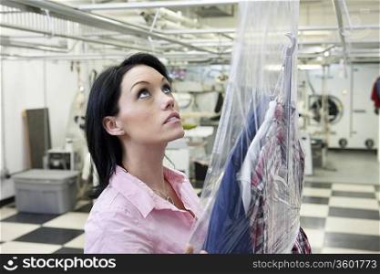 Beautiful woman looking up in laundry