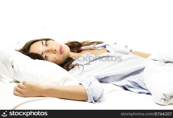 beautiful woman lying in bed. beautiful woman lying in bed on white background