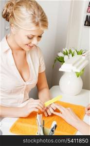beautiful woman making a manicure at the salon