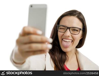 Beautiful woman making a selfie with the phone, isolated over white background