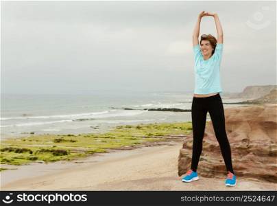Beautiful woman making fitness exercises in outdoor