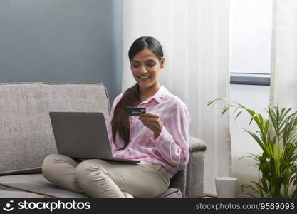 Beautiful woman making online payment from her card