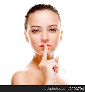 Beautiful woman making silence sign. Isolated over white. Focused on finger