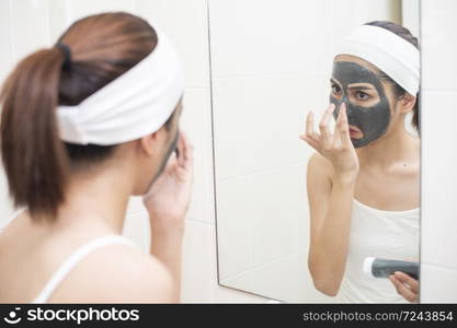 beautiful woman masking her face on white background