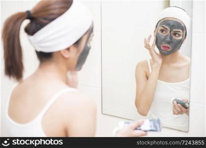 beautiful woman masking her face on white background