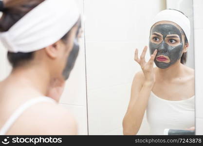 beautiful woman masking her face on white background