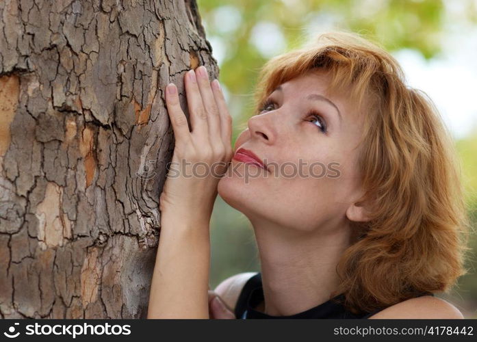 Beautiful woman near tree, with soft background