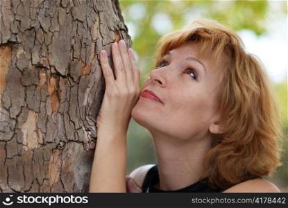 Beautiful woman near tree, with soft background