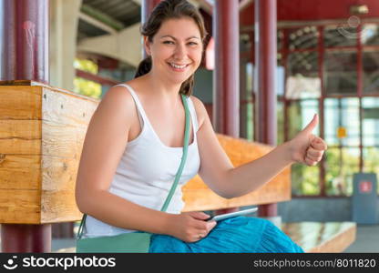 beautiful woman on a bench showing gesture enjoyment hand