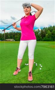 beautiful woman on a golf course looking behind a flying ball