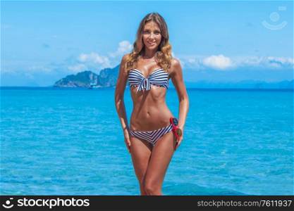 Beautiful woman on beach in Thailand, sea and islands on background. Beautiful woman on beach
