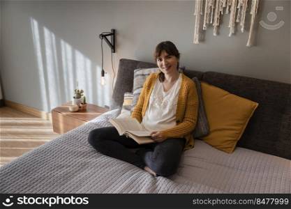 Beautiful woman on bed and reading a book