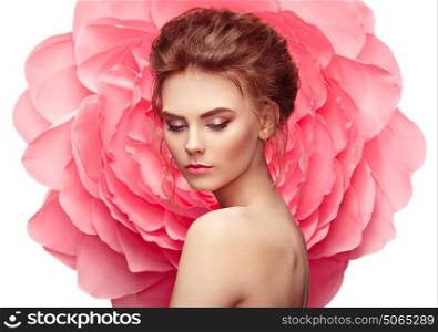 Beautiful woman on the background of a large flower. Beauty summer model girl with pink peony. Young woman with elegant hairstyle and makeup. Fashion photo