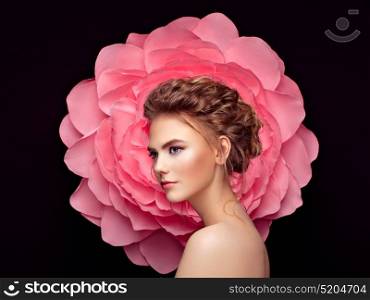 Beautiful woman on the background of a large flower. Beauty summer model girl with pink peony. Young woman with elegant hairstyle and makeup. Fashion photo