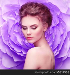 Beautiful Woman on the Background of a Large Flower. Beauty Summer Model Girl with Violet Peony. Young Woman with elegant Hairstyle and Makeup. Fashion Photo