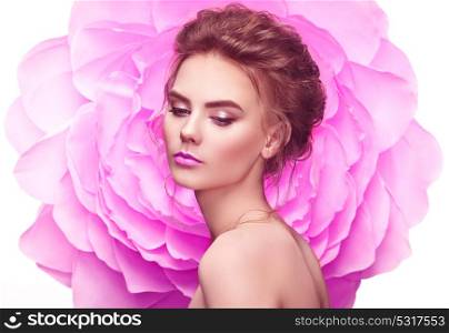 Beautiful Woman on the Background of a large Flower. Beauty Summer Model Girl with Pink Peony. Young Woman with elegant Hairstyle and Makeup. Fashion Photo