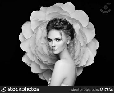 Beautiful Woman on the Background of a large Flower. Beauty Summer Model girl with Peony. Young Woman with Elegant Hairstyle and Makeup. Fashion photo