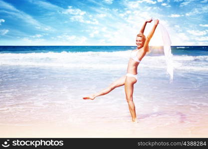 Beautiful woman on the beach, attractive slim model wearing white swimsuit and dancing with a scarf, enjoying summer holidays