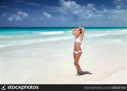 Beautiful woman on the beach, tanning on white sandy coast, spending summer holidays on Caribbean Sea, Cancun, Mexico, North America