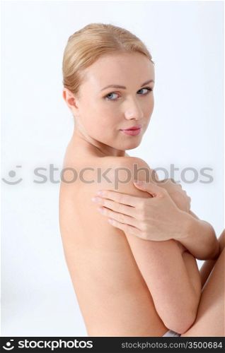 Beautiful woman on white background showing skin