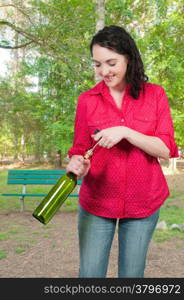 Beautiful woman opening a fine wine bottle