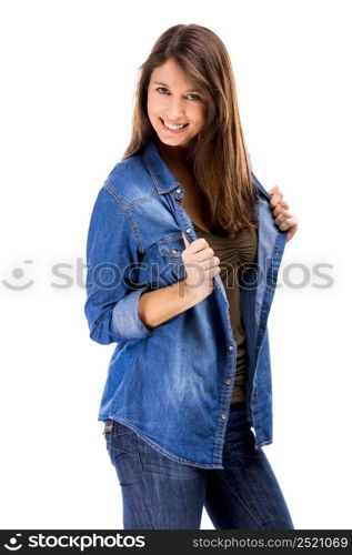 Beautiful woman over a white background holding her jeans shirt and smiling. Beautiful woman