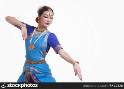 Beautiful woman performing Indian Bharat Natyam dance on white background