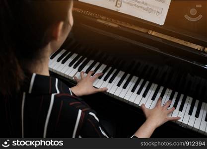 Beautiful woman playing piano, learn to play piano