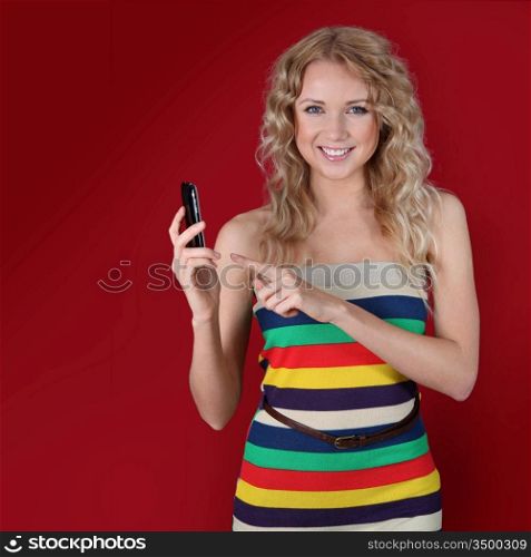 Beautiful woman pointing at mobilephone