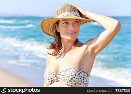 Beautiful woman portrait on the beach with hat