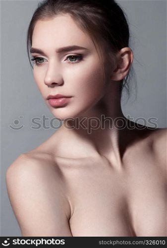 Beautiful woman portrait with natural makeup on grey