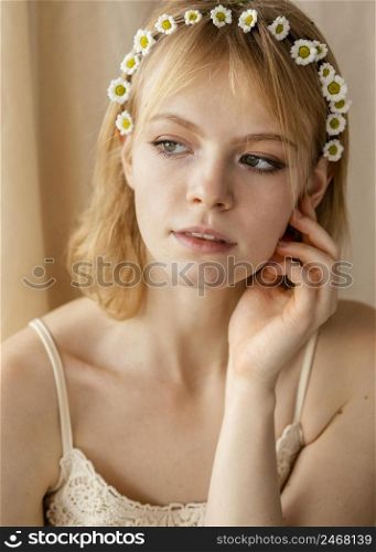 beautiful woman posing while wearing spring flowers crown